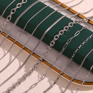 Assorted stainless steel silver chains including snake and cuban styles on jewelry tray