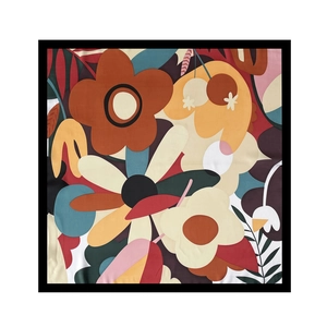 Flat lay of a square silk scarf featuring abstract floral patterns and vibrant color blocks