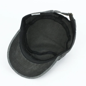 Detail view of cotton sun hat interior with adjustable metal buckle and care label