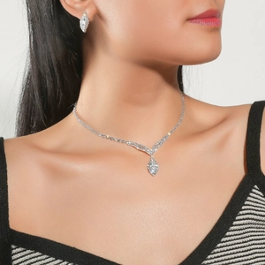 Detailed view of elegant bridal jewelry set featuring marquise-cut zircon on a model