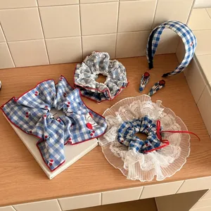 5-piece hair accessory set featuring blue gingham plaid and red cherry print patterns