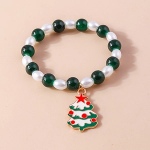 Detail of Christmas beaded bracelet with green gems, pearls and holiday tree charm