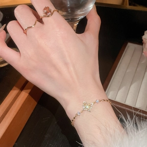 Detail of 18k gold butterfly bracelet with pavé zircons and elegant vintage ring set