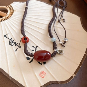 Detail of beaded necklace with carnelian, jadeite beads and Ruyi cloud silver charm