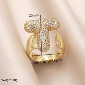 Detailed view of gold letter T ring with clear stones including size and weight specs