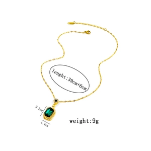 Detail view of emerald green pendant necklace with size specifications and golden finish