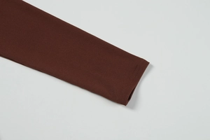 Close-up of deep brown long sleeve cuff with high-quality double-needle stitching detail