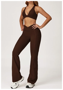 Detail of dark brown yoga set with V-cross waistband and flared pants on model