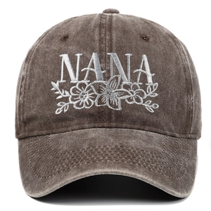 Macro detail of NANA embroidery and washed cotton texture on a brown baseball cap