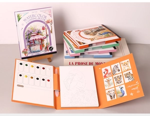 Close-up of portable watercolor book with built-in paint palette and animal sketches