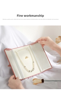 Close-up of pearl necklace and ring set displayed in a pink velvet jewelry gift box