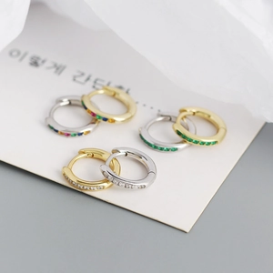 Macro detail of S925 silver huggie hoop earrings with colorful zircon stones