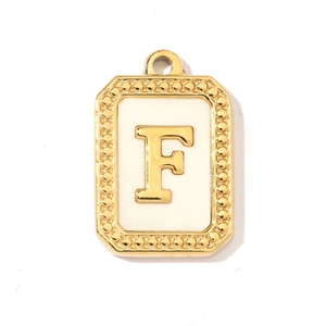 Close-up of a French vintage shell-style letter F pendant with gold beaded frame
