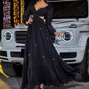 Detail of waist cut-out and sparkling butterfly embellishments on a black chiffon gown