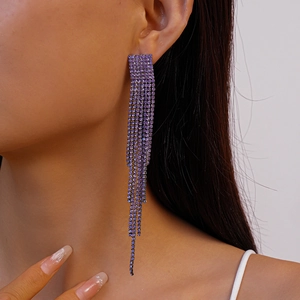 Close-up of elegant purple rhinestone tassel earrings worn on a model with sparkling detail