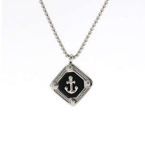 Vertical shot of a silver nautical anchor pendant with black enamel on a link chain