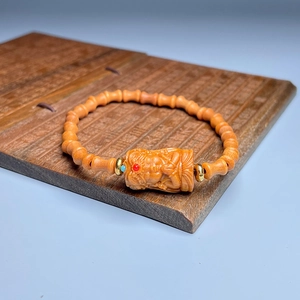 Bamboo-shaped sandalwood bracelet with carved deity bead in traditional Chinese style