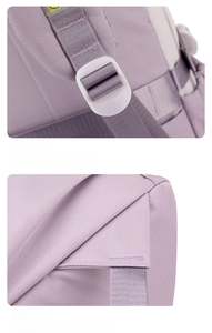 Detail of adjustable purple shoulder straps and reinforced stitching on durable backpack