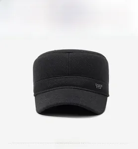 Detail of grey wool flat cap featuring a metallic Sports Style logo on the side