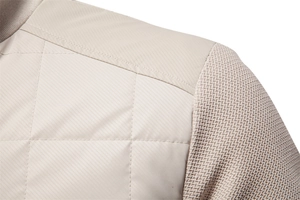 Detail of diamond quilted body and honeycomb texture knit sleeves on stand collar jacket