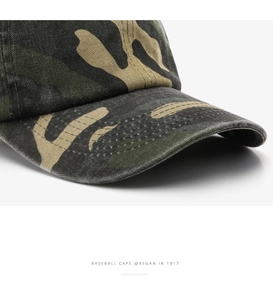 Detail of woodland camouflage baseball cap showing reinforced stitching on the curved brim