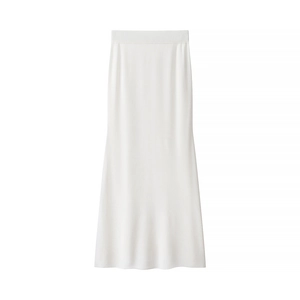 Detail of white knit midi skirt showing elegant ribbed texture and mermaid hemline