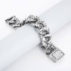 Close-up of vintage stainless steel snake link bracelet with textured scale pattern