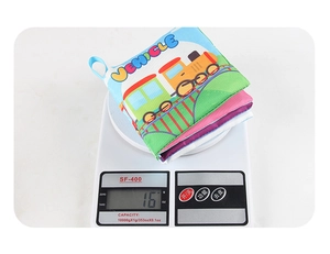 Detailed view of lightweight tear-proof baby cloth book weighing 16g on digital scale