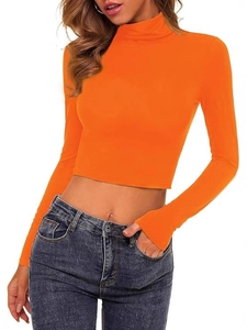 Orange long sleeve mock neck crop top for women paired with blue denim jeans