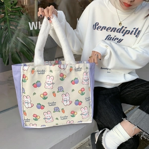 Detail of canvas tote bag with purple patchwork and fluffy white plush handles