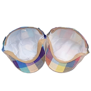 Detail view of colorful plaid beret featuring 100% polyester fabric and inner lining