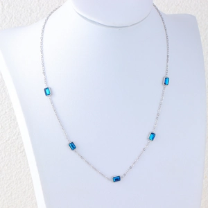 Silver necklace with five blue rectangular crystals on an elegant display model
