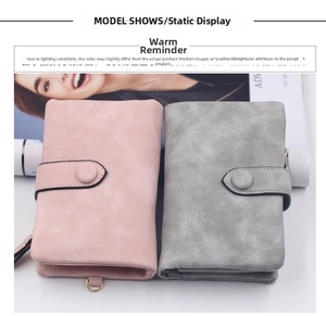 Close-up of pink and grey matte PU leather women's wallets with metal ring and snap button