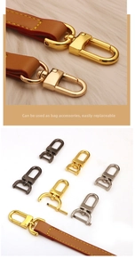 Close-up of metal bag strap swivel hooks and brown leather strap with yellow stitching