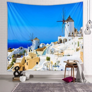 Detail of Santorini tapestry with blue dome buildings and windmill on a brick wall