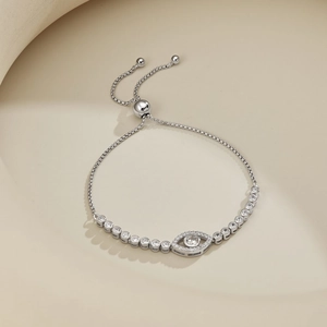 Detailed close-up of a silver slider bracelet featuring an evil eye charm with pavé zircon stones
