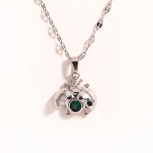 Chic silver ladybug pendant necklace with green gemstone and dainty O-chain link