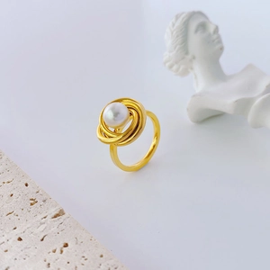 Elegant gold titanium multi-layer wrap ring with a white pearl on a stone pedestal