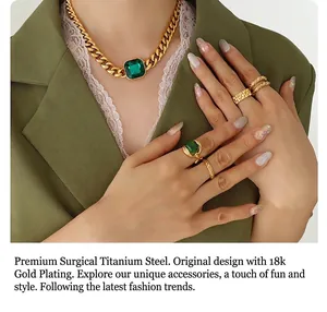 Detail of 18k gold plated titanium necklace with large green crystal stone on model