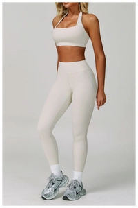 Detail of high-stretch cream yoga set featuring halter neck sports bra and leggings