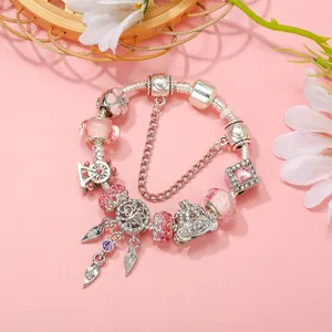 Silver plated charm bracelet featuring pink beads, ferris wheel and crown pendants