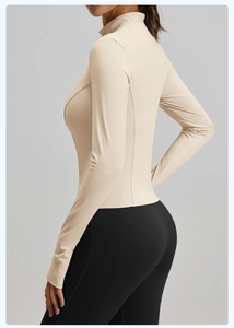 Detail of beige slim fit yoga jacket featuring breathable fabric and stand collar design