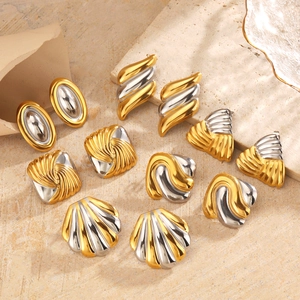 Two-tone oval shell earrings in gold and silver finish displayed on stone background