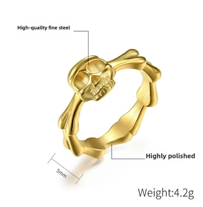 Macro shot of gold skull and bones steel ring detail with high polished finish