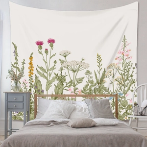 Detail of bohemian wall tapestry featuring hand-drawn wild floral and botanical patterns