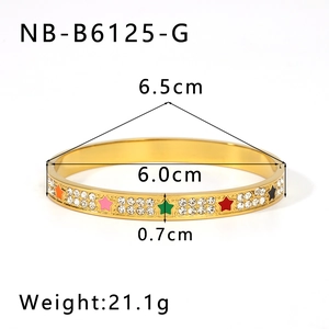 Detail showing 18K gold bangle with colorful star patterns and zircon encrusting