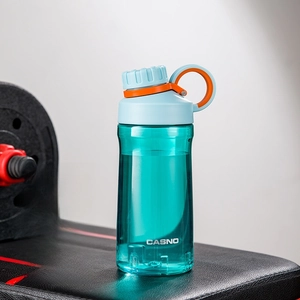 Close-up of 500ml green plastic sports water bottle with tea infuser on gym equipment