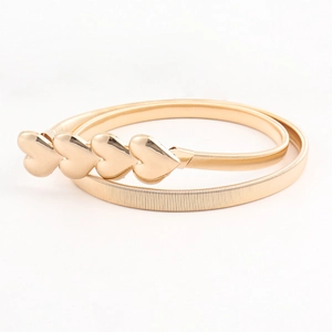 Detail of gold elastic metal belt featuring a four-heart shaped buckle on white background