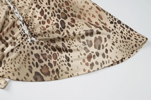Detail of leopard print dress with white side lacing and woven drawstring feature