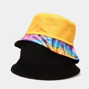 Women's trendy reversible tie-dye bucket hat in yellow and classic black cotton canvas